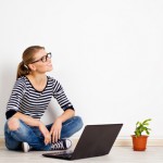 Young smiling woman dreaming of new home decor and furniture